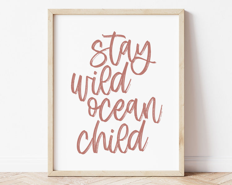 Dusky Rose Stay Wild Ocean Child Printable Wall Art featuring a textured brush style cursive lettered quote in a soft, dusty pink color. Perfect for Baby Girl Nautical Nursery Decor, Surf Nursery Wall Art, Beach Nursery Art, Nautical Kids Bedroom Decor or Children's Coastal Bathroom Wall Art.