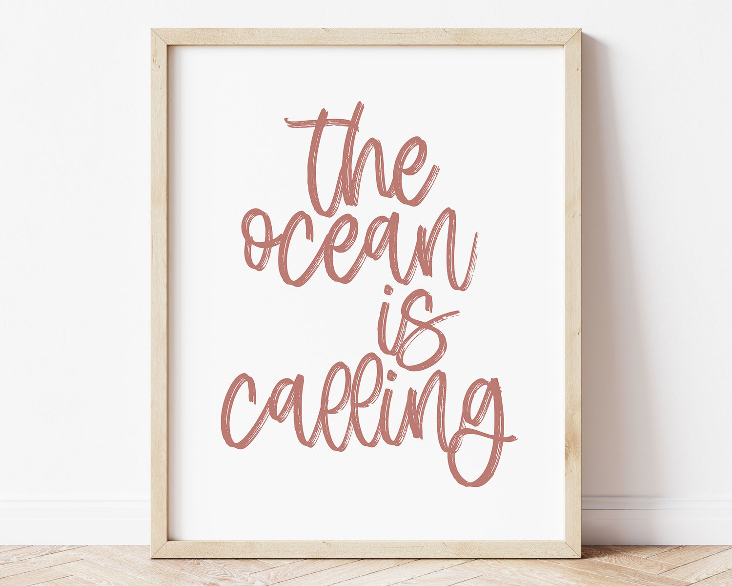 Dusty Rose The Ocean Is Calling Printable Wall Art featuring a textured brush style cursive lettered quote perfect for Baby Girl Nautical Nursery Decor, Baby Girl Surf Nursery Wall Art, Nautical Kids Bedroom Decor or Children's Coastal Wall Art.