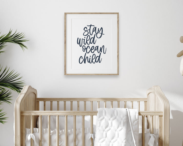 Navy Blue Stay Wild Ocean Child Printable Wall Art featuring a textured brush style cursive lettered quote in a dark blue color. Perfect for Baby Boy Nautical Nursery Decor, Baby Girl Surf Nursery Wall Art, Gender Neutral Beach Nursery Art, Nautical Kids Bedroom Decor or Children's Coastal Bathroom Wall Art.
