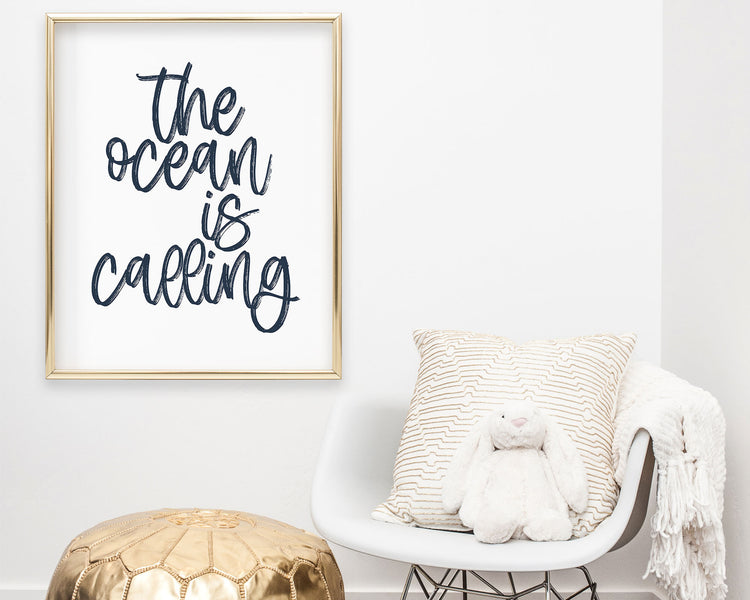 Navy Blue The Ocean Is Calling Printable Wall Art featuring a textured brush style cursive lettered quote perfect for Baby Boy Nautical Nursery Decor, Baby Girl Surf Nursery Wall Art, Nautical Kids Bedroom Decor or Children's Coastal Wall Art.
