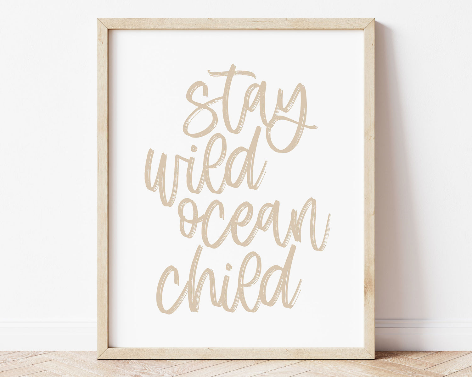 Neutral Tan Stay Wild Ocean Child Printable Wall Art featuring a textured brush style cursive lettered quote in a soft, neutral brown color. Perfect for Baby Boy Nautical Nursery Decor, Baby Girl Surf Nursery Wall Art, Gender Neutral Beach Nursery Art, Nautical Kids Bedroom Decor or Children's Coastal Bathroom Wall Art.
