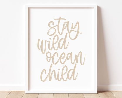Neutral Tan Stay Wild Ocean Child Printable Wall Art featuring a textured brush style cursive lettered quote in a soft, neutral brown color.