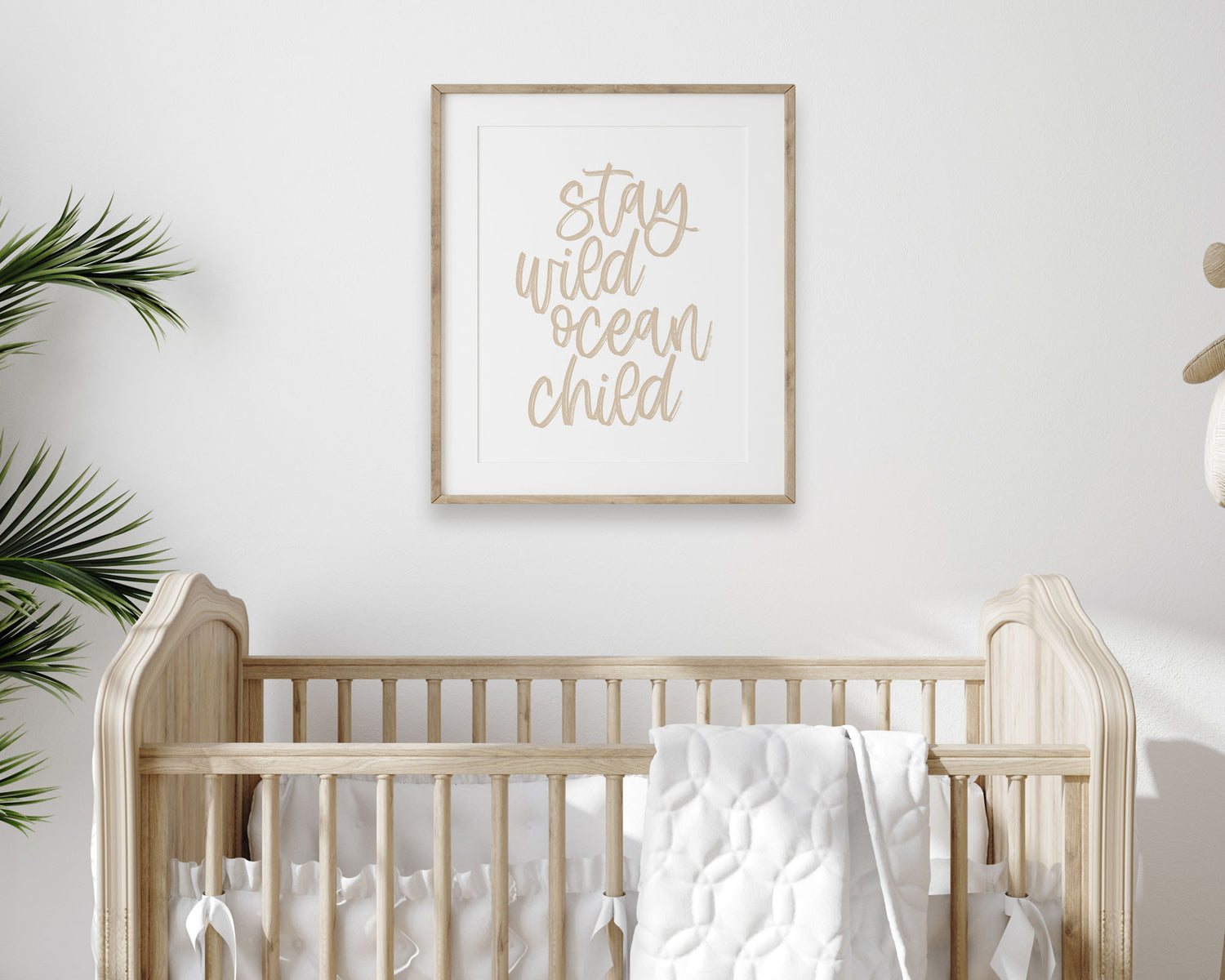 Neutral Tan Stay Wild Ocean Child Printable Wall Art featuring a textured brush style cursive lettered quote in a soft, neutral brown color. Perfect for Baby Boy Nautical Nursery Decor, Baby Girl Surf Nursery Wall Art, Gender Neutral Beach Nursery Art, Nautical Kids Bedroom Decor or Children's Coastal Bathroom Wall Art.