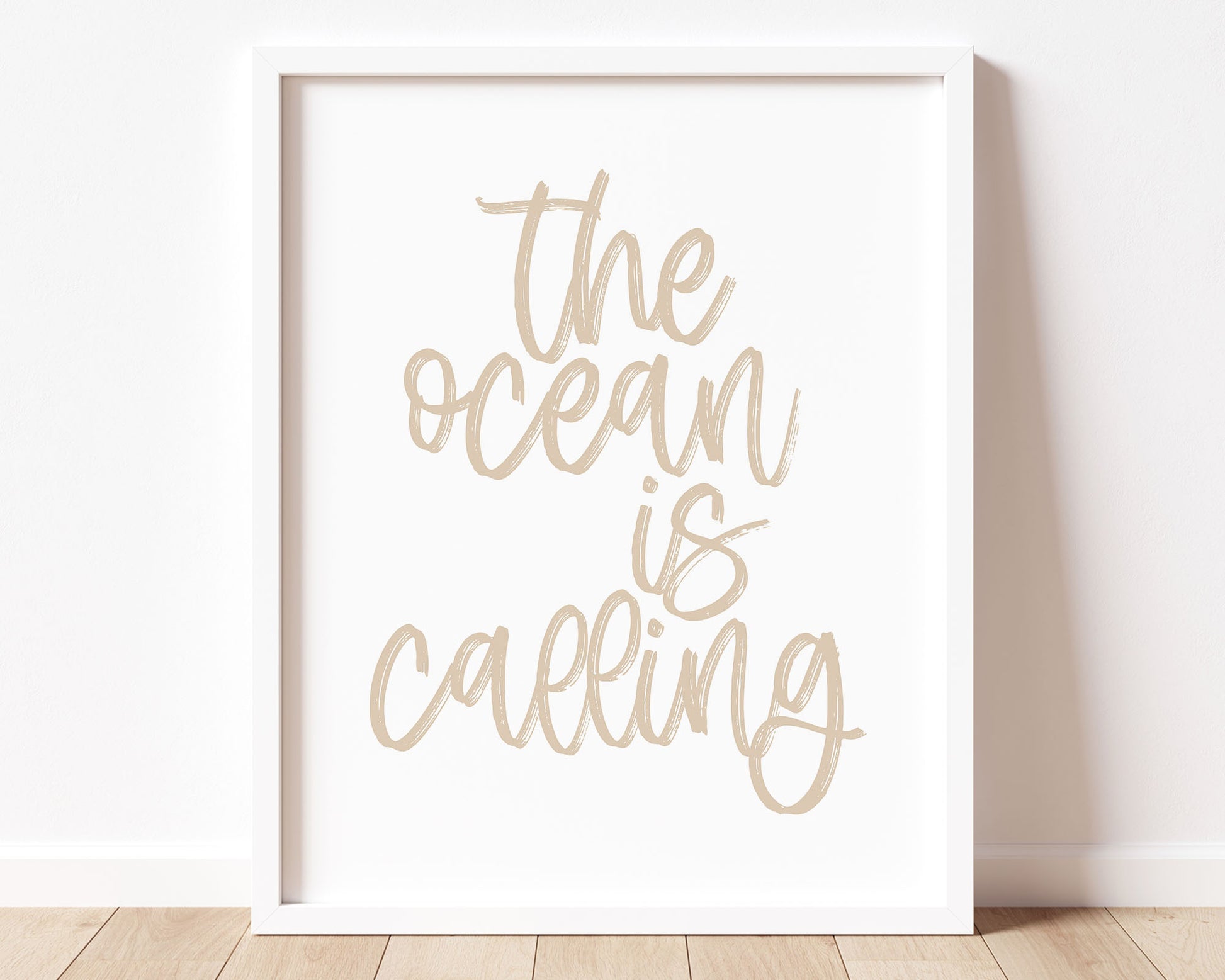 Neutral Tan colored The Ocean Is Calling Printable Wall Art featuring a textured brush style cursive lettered quote.