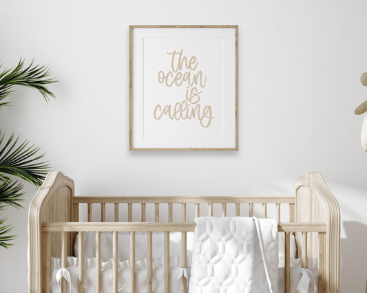 Neutral Tan The Ocean Is Calling Printable Wall Art featuring a textured brush style cursive lettered quote perfect for Baby Boy Nautical Nursery Decor, Baby Girl Surf Nursery Wall Art, Nautical Kids Bedroom Decor or Children's Coastal Wall Art.