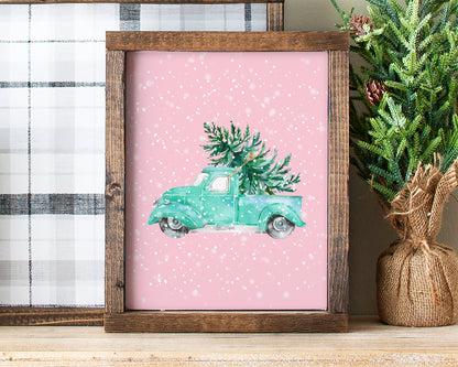 Watercolor Teal / Turquoise Vintage Christmas Truck with Christmas Tree on a pink background with a dreamy snowflake effect.