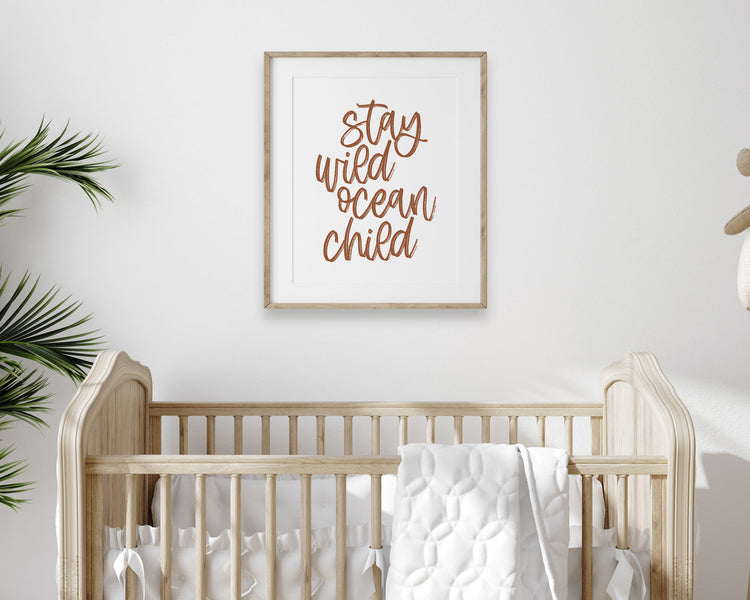 Earth Tone Stay Wild Ocean Child Printable Wall Art featuring a textured brush style cursive lettered quote in a rust / clay / terracotta color. Perfect for Baby Girl Nautical Nursery Decor, Baby Boy Surf Nursery Wall Art, Gender Neutral Beach Nursery Art, Nautical Kids Bedroom Decor or Children's Coastal Bathroom Wall Art.